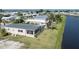 Aerial view of a house with a Florida room situated on a waterfront lot at 109 Lakeview Dr, North Port, FL 34287