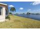 Backyard with waterfront view of a lake and other homes at 109 Lakeview Dr, North Port, FL 34287