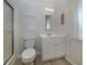Bathroom with white vanity, toilet, and shower stall with decorative wall covering at 109 Lakeview Dr, North Port, FL 34287