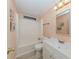 Bathroom with white vanity, toilet, and shower/tub combo with peach walls at 109 Lakeview Dr, North Port, FL 34287
