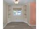 Dining room with built-in shelving, window, and modern wood-look flooring at 109 Lakeview Dr, North Port, FL 34287
