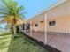 Mobile home exterior with carport, landscaping, and palm tree at 109 Lakeview Dr, North Port, FL 34287