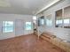 A Florida room with a door, windows and a decorative glass front door at 109 Lakeview Dr, North Port, FL 34287