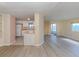 Open concept kitchen and living area with light wood-look flooring at 109 Lakeview Dr, North Port, FL 34287