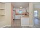 Kitchen with breakfast bar, white cabinets, and peach walls at 109 Lakeview Dr, North Port, FL 34287
