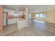 Bright kitchen with white cabinets, light countertops, and view to living area at 109 Lakeview Dr, North Port, FL 34287
