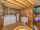 Laundry room with washer, dryer, utility sink, and storage shelves at 109 Lakeview Dr, North Port, FL 34287