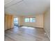 Spacious living room with wood-look flooring and sliding glass doors to a patio at 109 Lakeview Dr, North Port, FL 34287