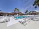 Large community pool with numerous lounge chairs for relaxation at 109 Lakeview Dr, North Port, FL 34287
