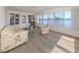 Sunroom with lake views, a ceiling fan, and comfortable furniture at 109 Lakeview Dr, North Port, FL 34287