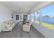 Spacious sunroom with large windows showcasing waterfront views and lush greenery at 109 Lakeview Dr, North Port, FL 34287