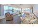 Sunroom with scenic lake views, comfortable seating, and wood-look flooring at 109 Lakeview Dr, North Port, FL 34287
