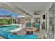 Spacious pool area with covered patio and seating at 1567 Waterford Dr, Venice, FL 34292