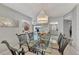 Open dining area with a glass top table and a chandelier at 1567 Waterford Dr, Venice, FL 34292