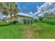 Landscaped backyard with lush lawn and home exterior at 1567 Waterford Dr, Venice, FL 34292