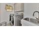 Laundry room with washer, dryer, sink, and cabinets at 1567 Waterford Dr, Venice, FL 34292