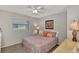 Bright bedroom with a queen bed, ceiling fan, and window coverings at 1567 Waterford Dr, Venice, FL 34292