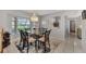Bright dining room featuring a glass-top table and neutral decor at 1567 Waterford Dr, Venice, FL 34292