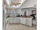 Modern kitchen with white cabinets, stainless steel appliances, and breakfast bar at 1567 Waterford Dr, Venice, FL 34292