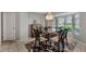 Elegant dining room with glass table, chandelier, and bay window at 1567 Waterford Dr, Venice, FL 34292