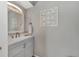 Clean bathroom with vanity, mirror, and decorative wall art at 1567 Waterford Dr, Venice, FL 34292