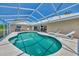 Inviting pool area with screened enclosure and lounge chairs at 1567 Waterford Dr, Venice, FL 34292