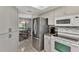 Open kitchen with stainless steel appliances and view to dining area at 1567 Waterford Dr, Venice, FL 34292