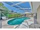 Screened-in pool with lounge chairs and patio furniture at 1567 Waterford Dr, Venice, FL 34292