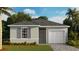 One-story house with grey exterior and a two-car garage at 14461 Bulger Ave, Port Charlotte, FL 33953
