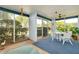 Screened lanai with seating for relaxing at 1350 Stafford Ln # 1422, Sarasota, FL 34232
