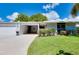 Bright, white home with a two-car garage and manicured lawn at 1350 Stafford Ln # 1422, Sarasota, FL 34232
