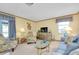 Bright living room features comfortable seating and a large TV, creating a cozy atmosphere at 1350 Stafford Ln # 1422, Sarasota, FL 34232