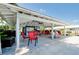 Relaxing covered patio area with seating near the pool at 1350 Stafford Ln # 1422, Sarasota, FL 34232