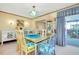 Elegant dining room featuring a glass table, chandelier, and stylish seating at 1350 Stafford Ln # 1422, Sarasota, FL 34232