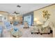 Open living area with comfortable seating, a dining area, and access to a patio at 1350 Stafford Ln # 1422, Sarasota, FL 34232