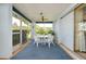 Bright screened porch with patio furniture, ideal for relaxing and enjoying the Florida sunshine at 1350 Stafford Ln # 1422, Sarasota, FL 34232