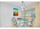 Bright breakfast nook with glass table and four chairs, ideal for casual dining at 1350 Stafford Ln # 1422, Sarasota, FL 34232