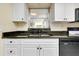 Well-equipped kitchen with granite countertops and a large sink with a view at 1350 Stafford Ln # 1422, Sarasota, FL 34232