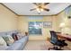 Bright home office features a desk, chair, and a comfortable sofa at 1350 Stafford Ln # 1422, Sarasota, FL 34232