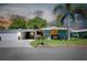 Ranch-style home with attached garage and landscaped lawn at 1350 Stafford Ln # 1422, Sarasota, FL 34232
