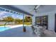 Charming patio with a dining table overlooking the pool and waterfront view at 5885 Denison Dr, Venice, FL 34293