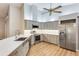 Modern kitchen with stainless steel appliances and gray cabinets at 5723 Garden Lakes Dr, Bradenton, FL 34203