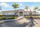 Community clubhouse entrance with palm trees and landscaping at 13360 Esposito St, Venice, FL 34293