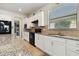 A spacious kitchen offers stainless appliances, granite counters, white cabinets, and plenty of counter space at 13360 Esposito St, Venice, FL 34293