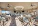 Community clubhouse lounge with tables, chairs, and TVs at 13360 Esposito St, Venice, FL 34293
