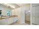 Bathroom featuring granite counters, white cabinetry, and walk-in shower at 334 Melrose Ct, Venice, FL 34292