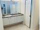 Bathroom featuring vanity with cabinets, a sink, and large mirror at 334 Melrose Ct, Venice, FL 34292