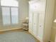 Bedroom with a Murphy bed, shuttered window, and small side table with a lamp at 334 Melrose Ct, Venice, FL 34292