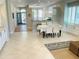 Bright dining area featuring tile flooring and stylish furnishings, open to kitchen and entryway at 334 Melrose Ct, Venice, FL 34292