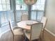 Bright dining area with white plantation shutters and a stylish light fixture creating an inviting atmosphere at 334 Melrose Ct, Venice, FL 34292